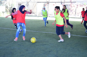 Girls during a football life skills through sports learning course