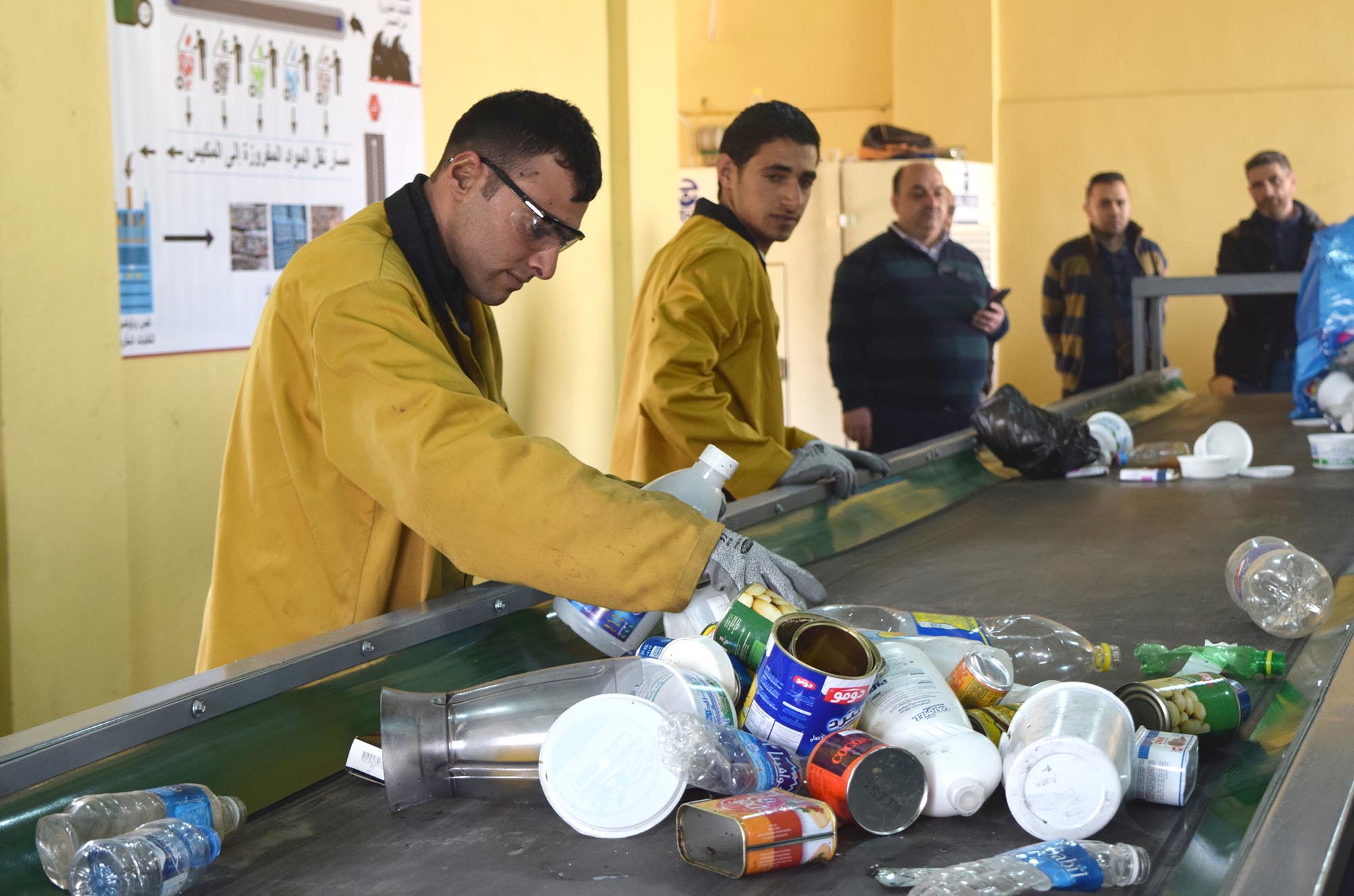 Workers at the Mashha sorting facility