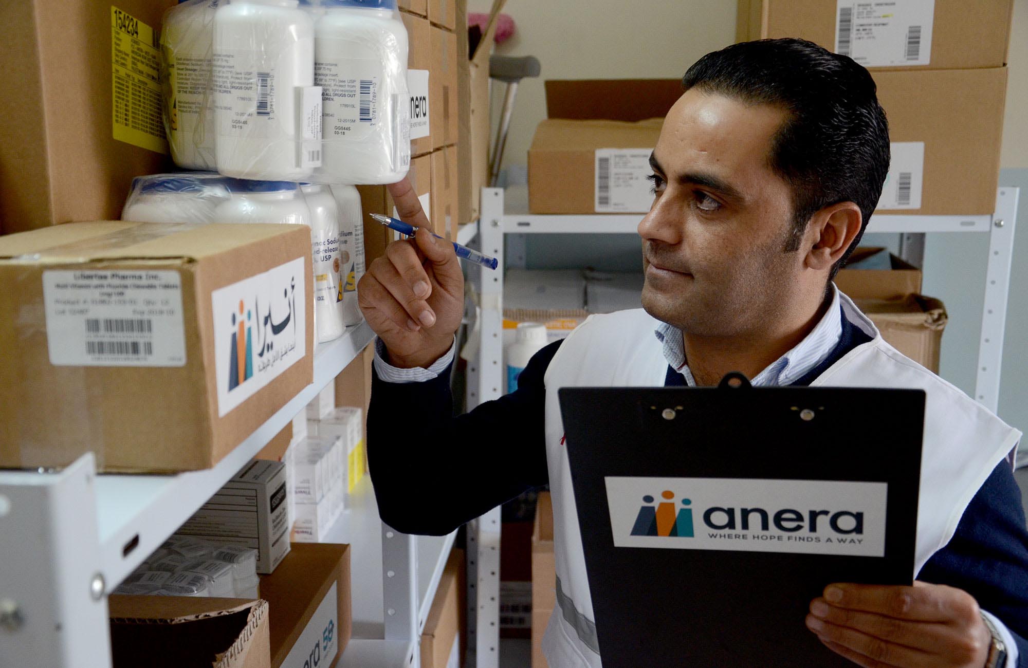 An Anera pharmacist does inventory in West Bank.