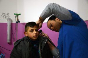 Dr. Ammar Al-Haddad with 11-year-old patient Riad Al-Sharha.