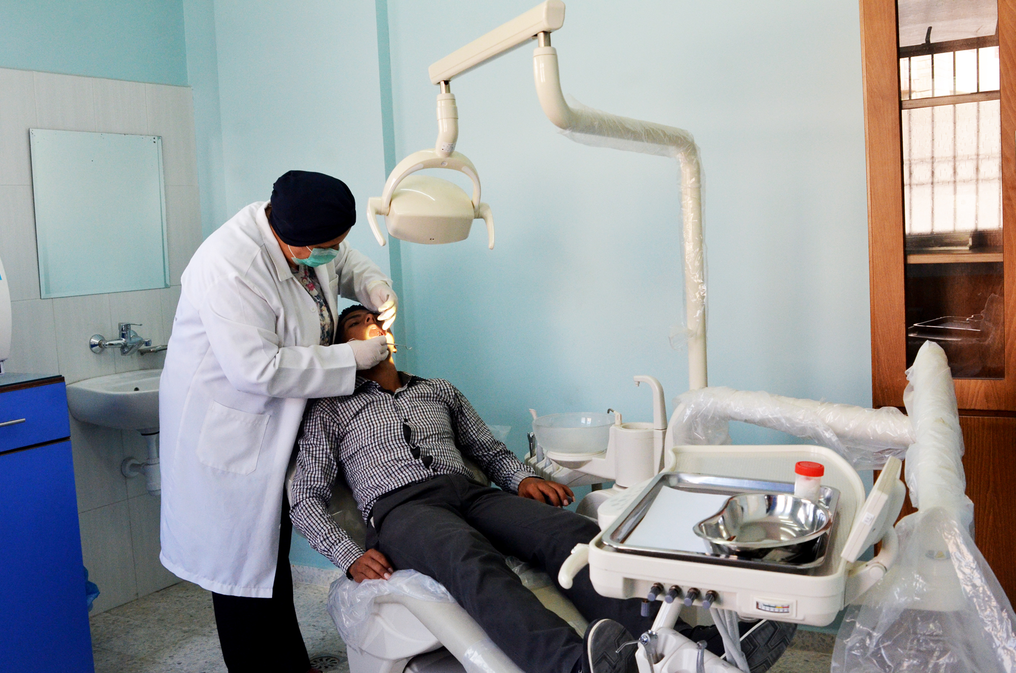 Dr. Abu Haloub checks up the oral health of one of her patients in the Anera built Beit Lahia Health Clinic.