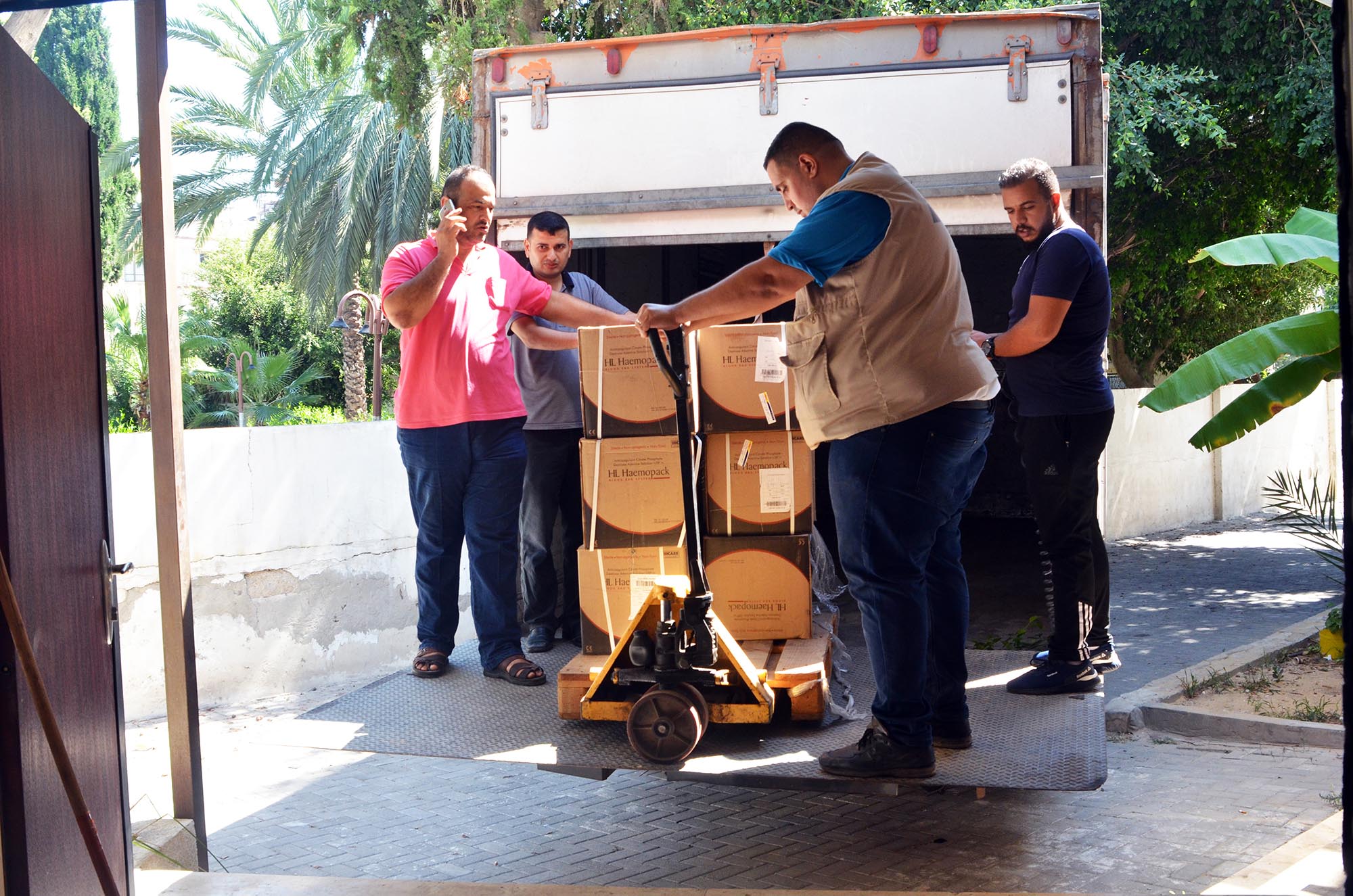 Anera's Gaza staff unload the new dialysis machines at Al-Shifa Hospital.