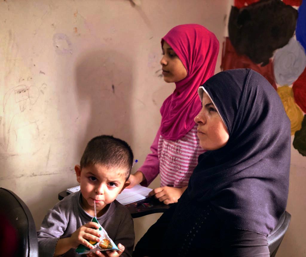 Amina in class with her son.