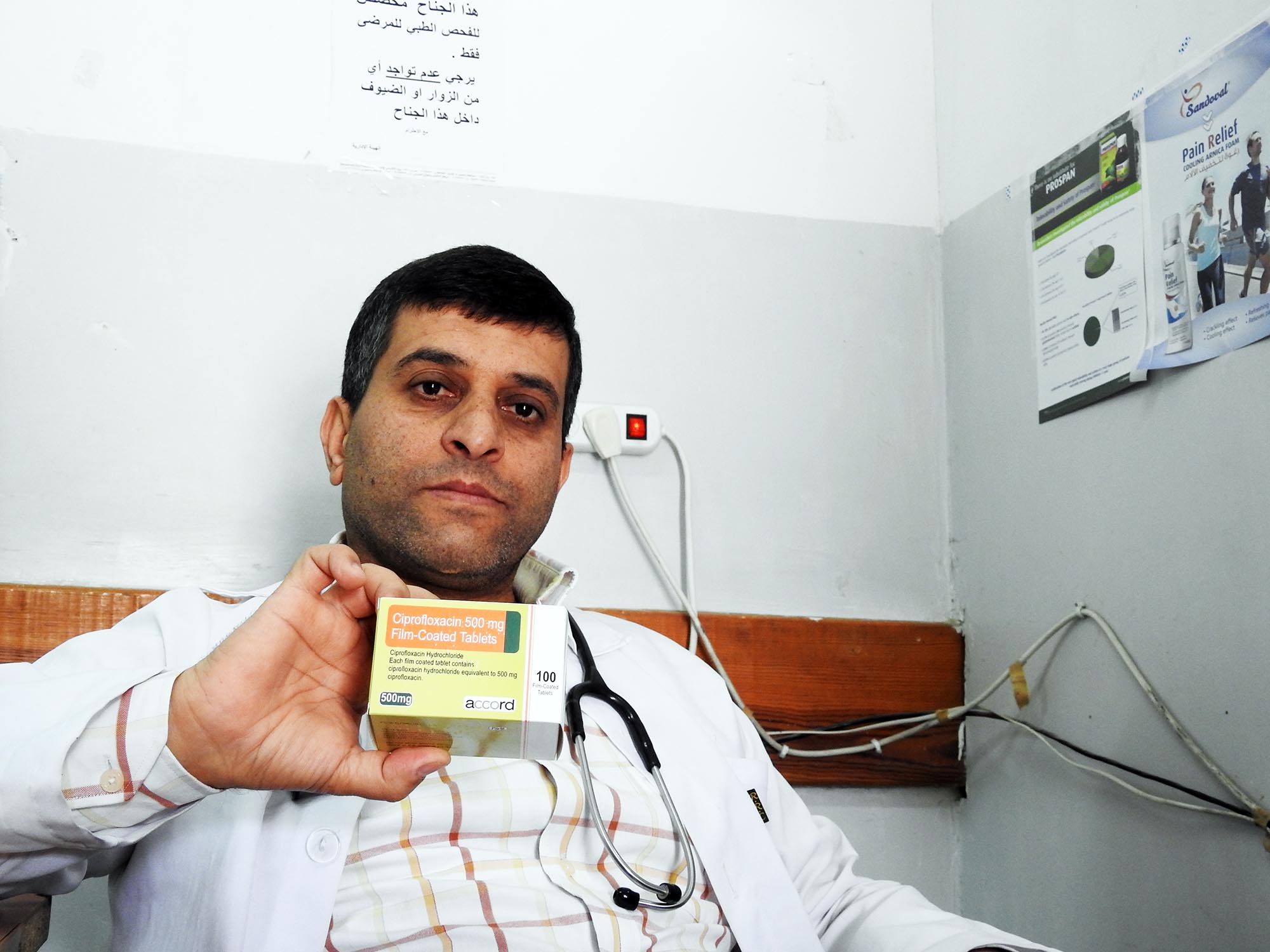 Dr. Ismael holding the donated medicine which he prescribed for a UTI.