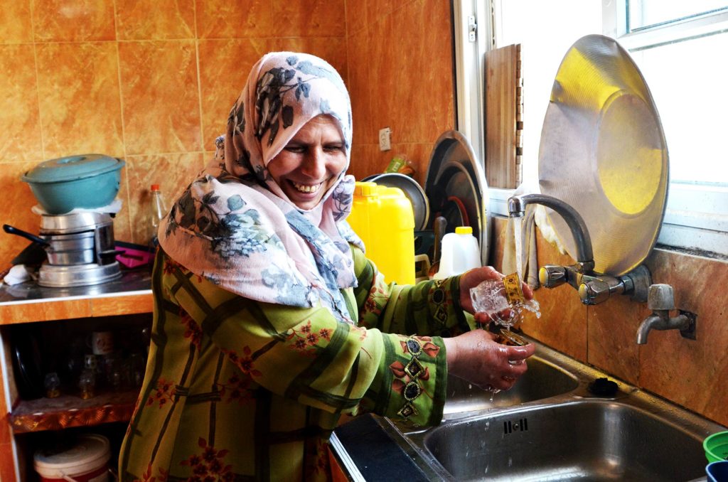 Rasmiya can now enjoy access to clean water in her own home after Anera rehabilitated the Abassan water well in Beit Lahia, Gaza.