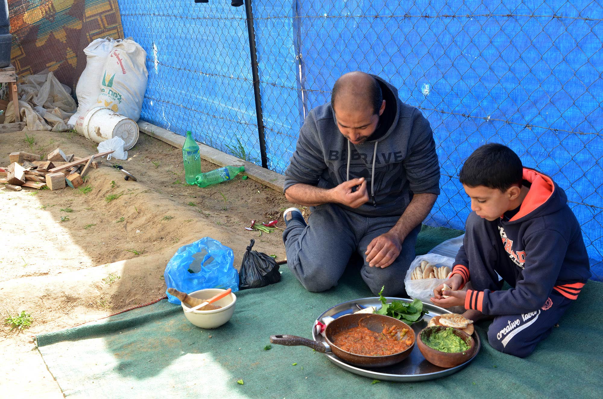 Mohamed and his son Moetasem enjoy their healthy meal.