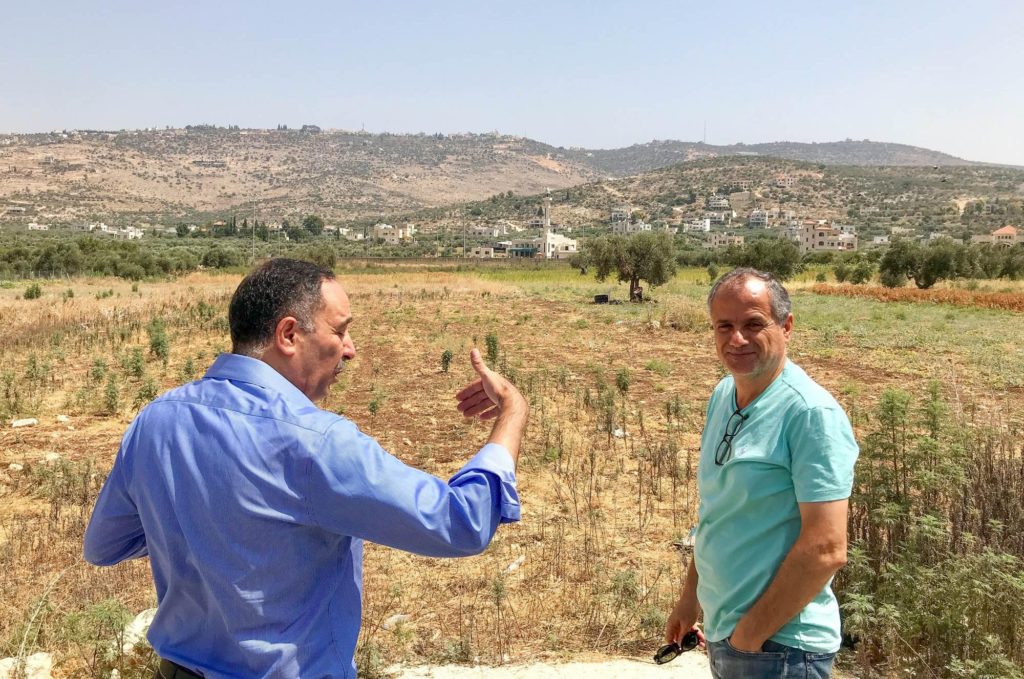 Nader Barakat with Anera staff at the site of land under consideration for the community center project.
