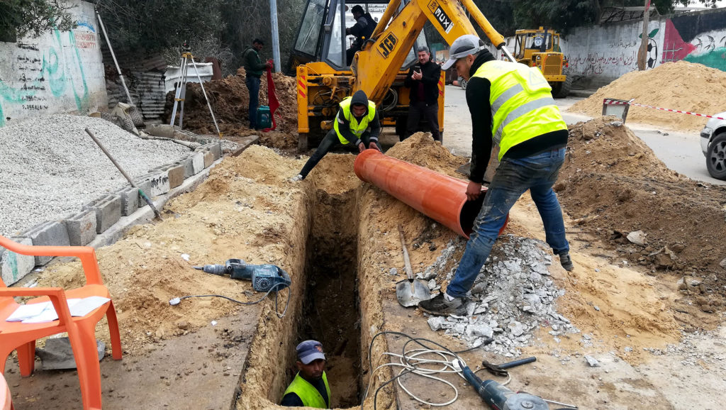 Workers installing storm-water drainage pipes in Beit Hanoun.