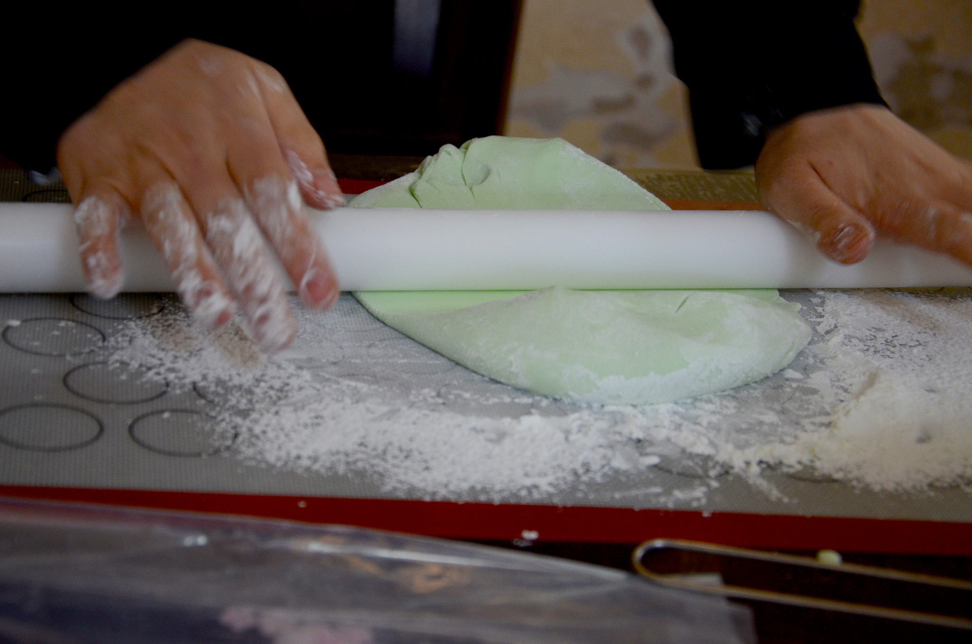 Johaina rolls her rollingpin over freshly made dough for a cake.