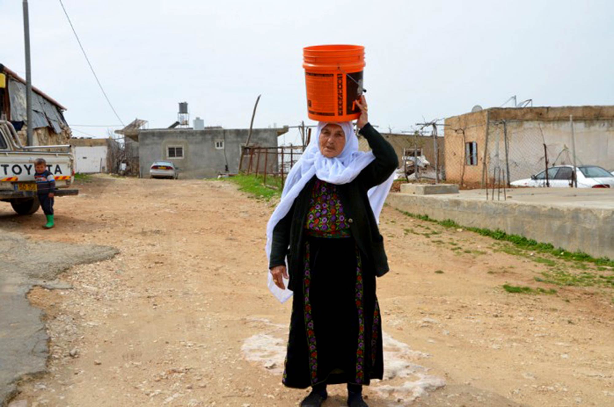 “Water is the backbone of my life,” says Hajje Fatmeh. At 80, she is still active as a cattle herder. Fatmeh lives in Imneizel, a Bedouin community in Area C. The remote village had no water network until the PCID program built a water tank and installed water pipes and house connections. For most of her life she would walk for an hour every other day to the village well and carry back five buckets of water – “four on the donkey and one on top of my head!” “Having [water] in your home is a blessing of incalculable worth!,” Hajje Fatmeh reminds us.