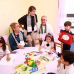 The Stengel family with school children at an arts and crafts table in the new Ni'lin preschool