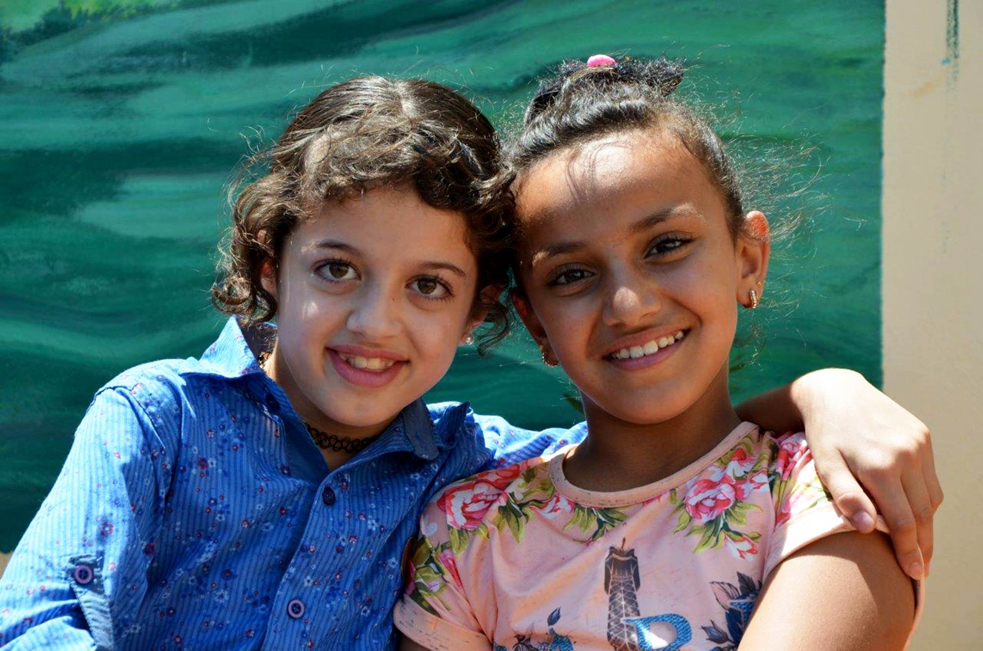 Um-Salamuna, Public-Park, PCID, Palestinian At the end of the summer of 2017, Um Salamuna Park officially opened to the public. On a beautiful summer day, 10-year-old Ruwaidah Mustafa suddenly stops playing on the seesaw and decides to tell us about her new best friend. With a smile on her young face, she introduces us to 9-year-old Ahlam. The two met at the park earlier this summer – a park Ruwaidah describes as “pretty, colorful, and, most importantly, clean!” Ahlam lives on the other side of the village, but still within walking distance of the new park. “I knew of Ahlam before but we weren’t really friends until I actually met her here and we started playing together.” Not only has Ruwaidah made new friends, but her mother has as well, becoming friends with Ahlam’s mother. “This has been the best summer of my life!” Ruwaidah shouts just before she pushes herself down the bright blue slide.