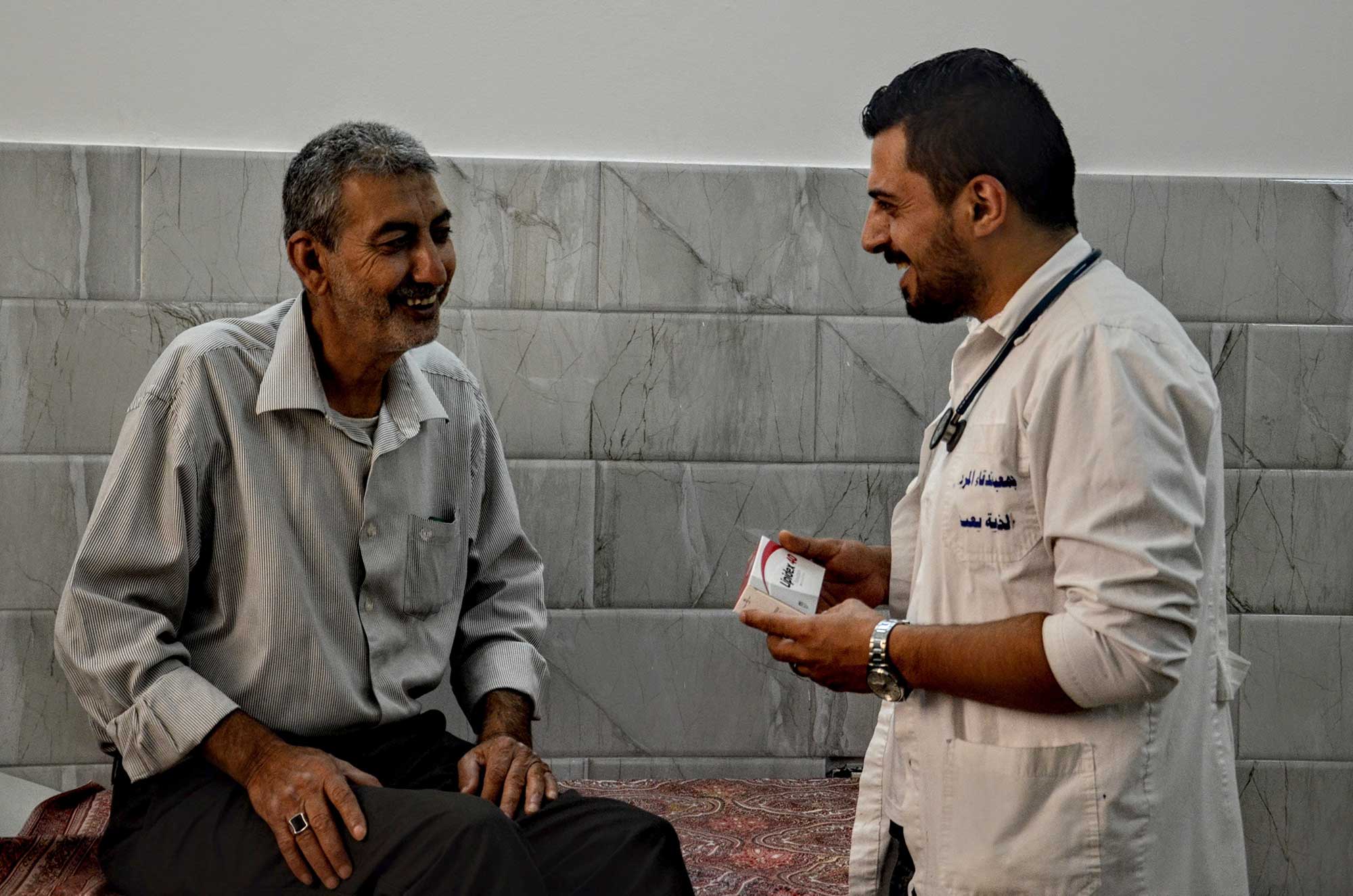 Mohammed gets advice from Foad Alkilani, a doctor at the Yabad Clinic.