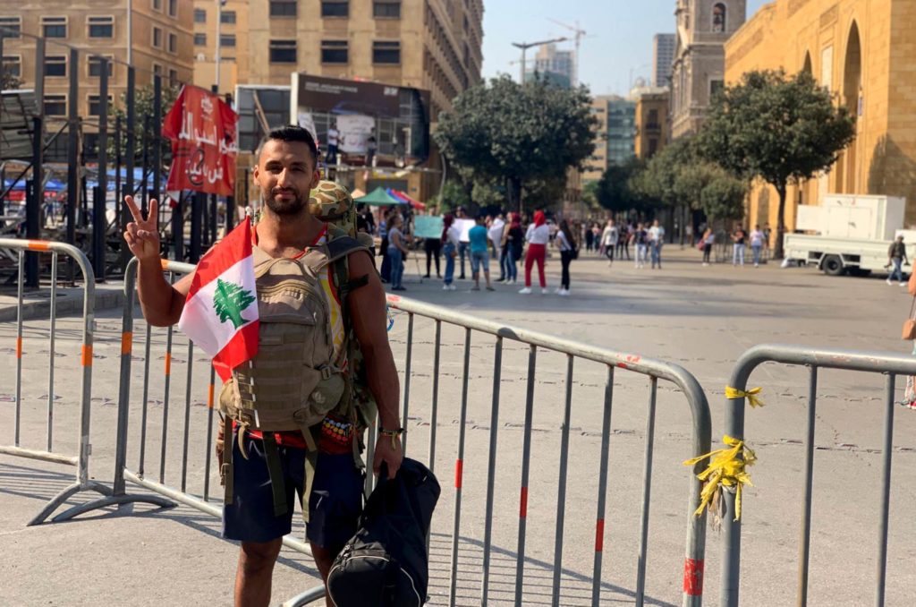 Charles in Beirut with Lebanese flag following his hike.