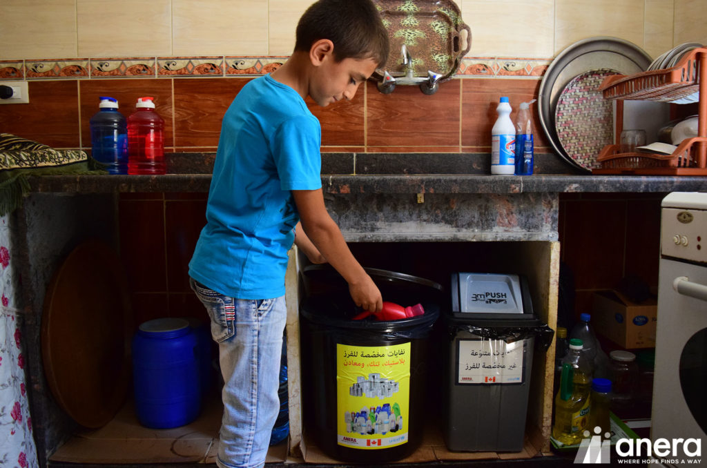A child participates in Anera's solid waste management program in Lebanon. In addition to building waste management facilities with recycling and compost capabilities, the program encourages households to sort their waste to facilitate separation for recycling and compost.