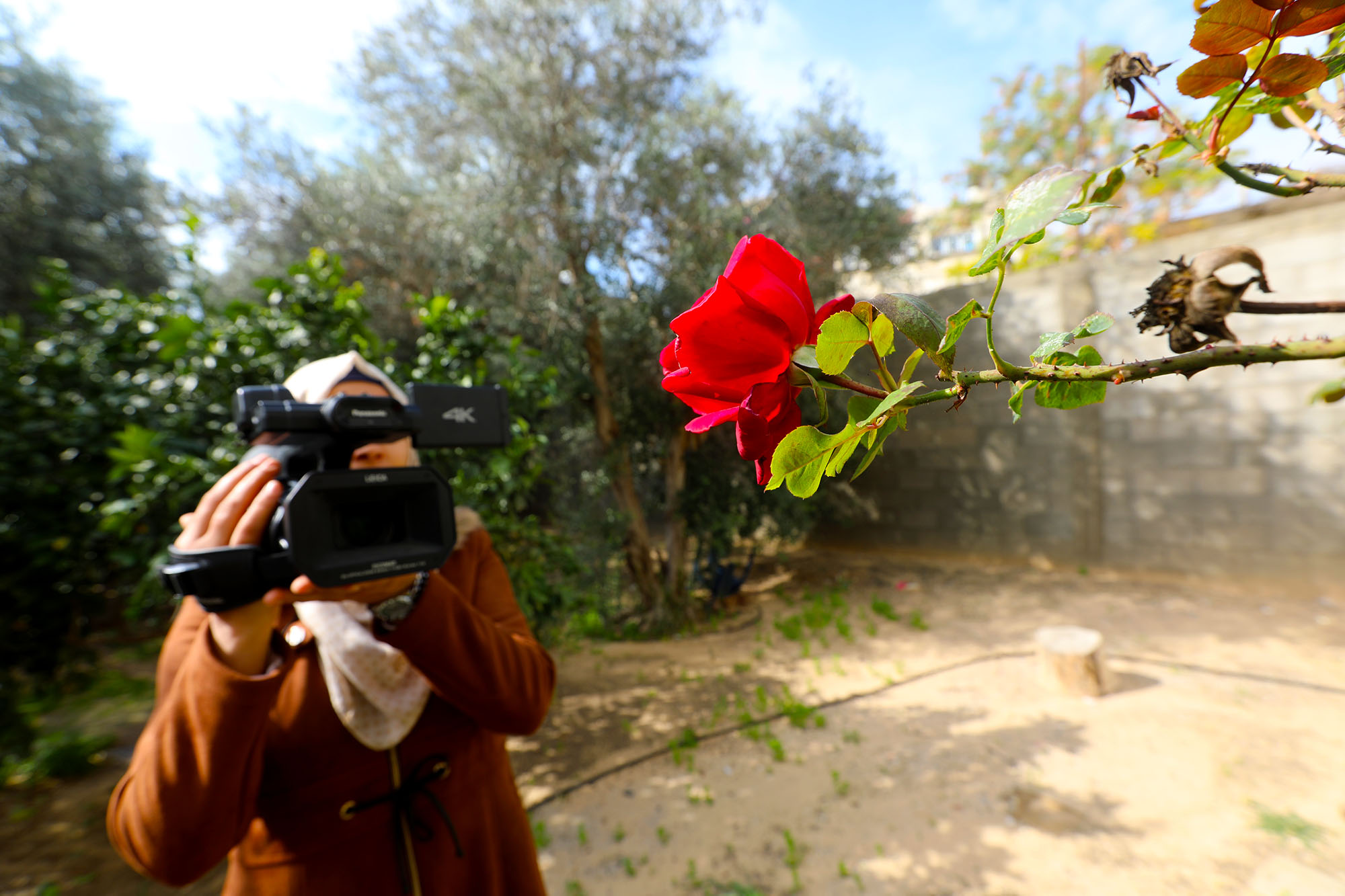 A Palestinian woman in Beit Hanoun, Gaza operates a video camera as part of a training course offered by Anera in photography.