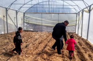 The Joudah family in Rafah, Gaza, exploring their new greenhouse.