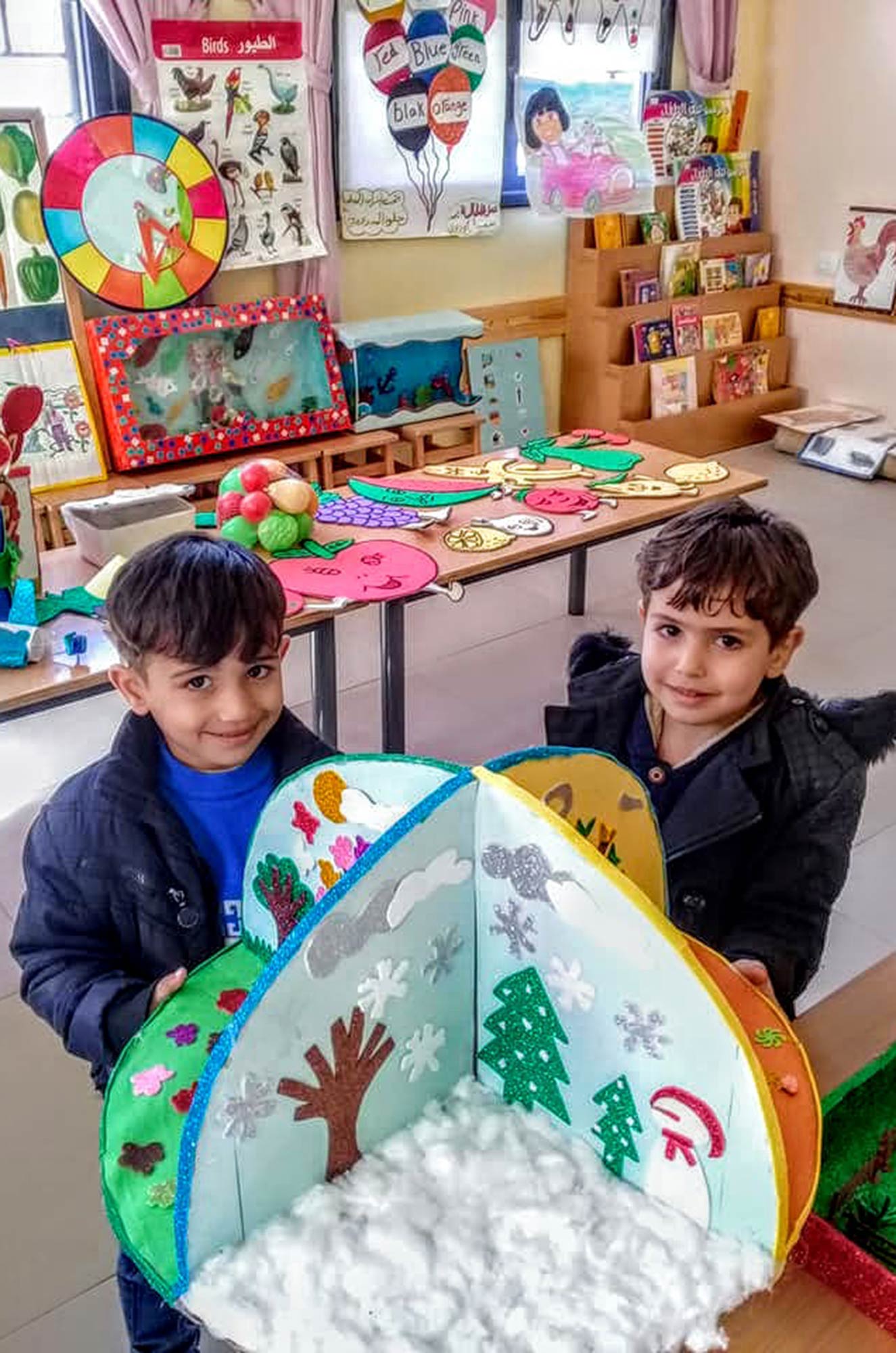 Two boys display their project at their new preschool in Gaza’s Nuseirat Refugee Camp.