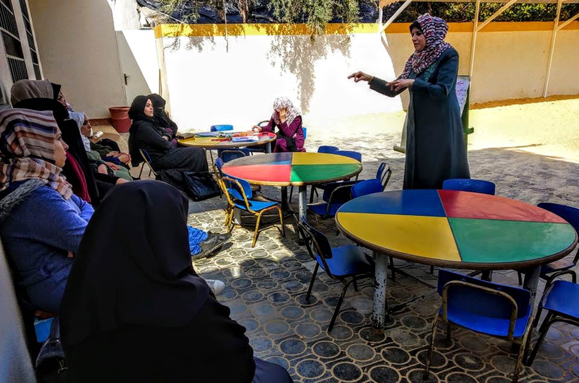 A new preschool for refugee children in Gaza, Amal-Arandas Amal Arandas, principal of Nuseirat Preschool, talks to a group of women at the new preschool.