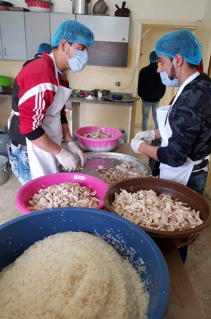 Vocational cooking students help prepare hot Ramadan meals for distribution in the village of Bibneen in Akkar, Lebanon.