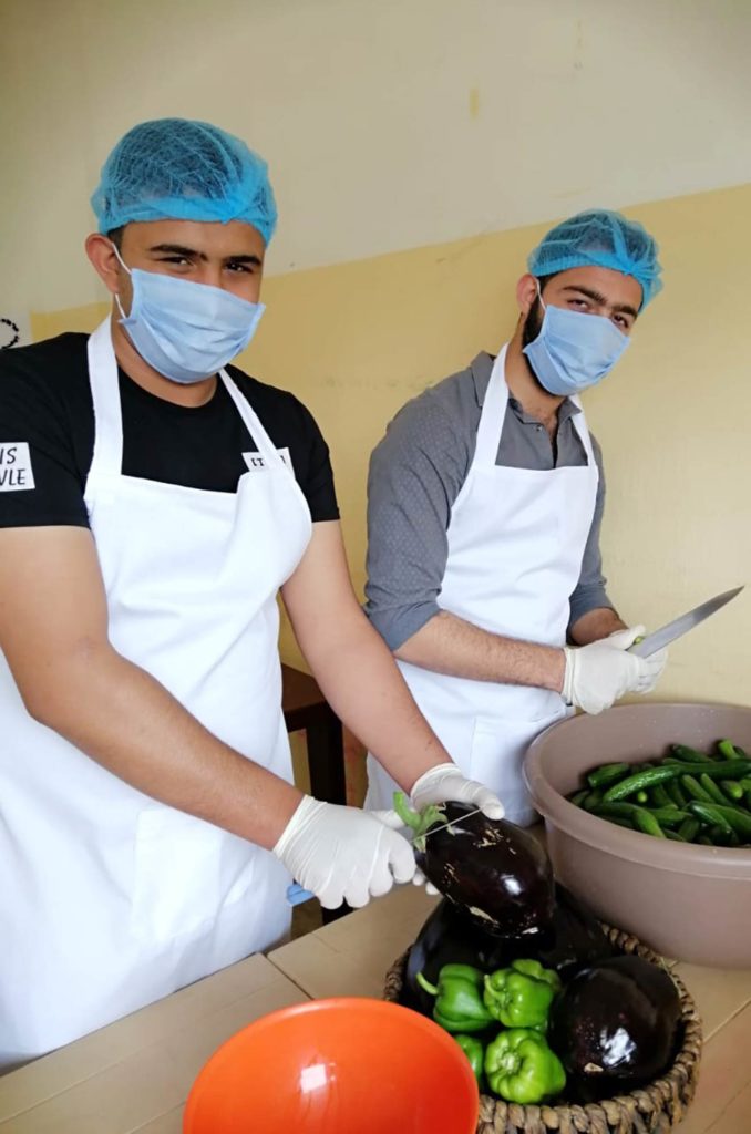 Vocational cooking students prepare cucumbers and eggplants.
