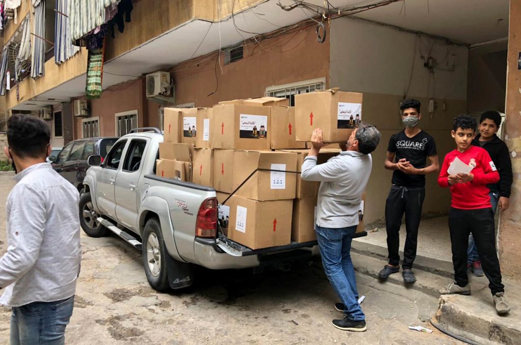 Loading a pickup truck with food parcels for distribution