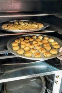 Qalqilya, Palestine, women's-empowerment, Women-Can, baker, Nadera, maamoul in the oven Maamoul cookings coming out of the oven!