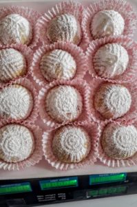 Nadera's powdered maamoul cookies on a weight scale.