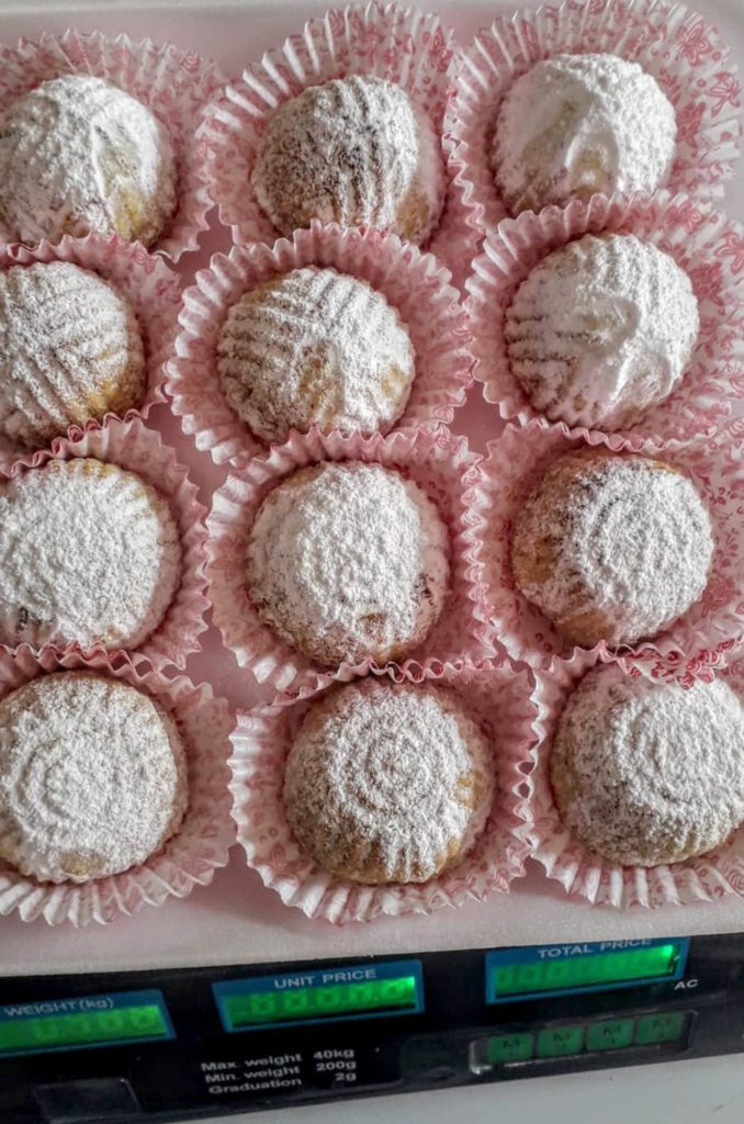 Nadera's powdered maamoul cookies on a weight scale.