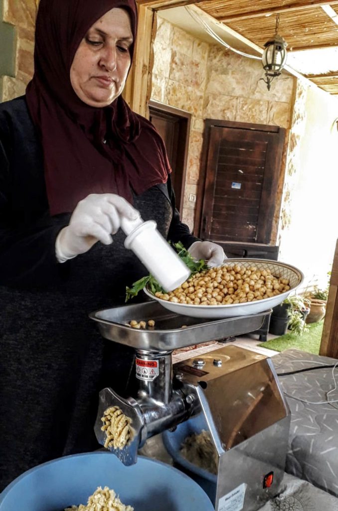 Nadera in her kitchen using her new chickpea grinder to make falafel.