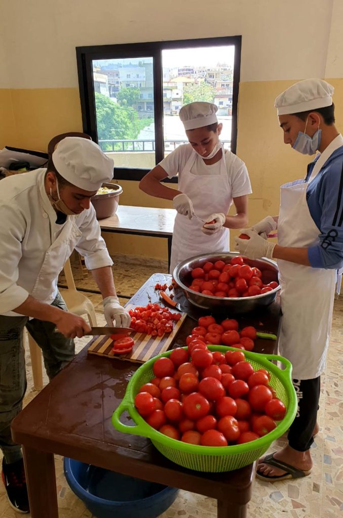 Vocational cooking students prepare tomatoes for Ramadan meals