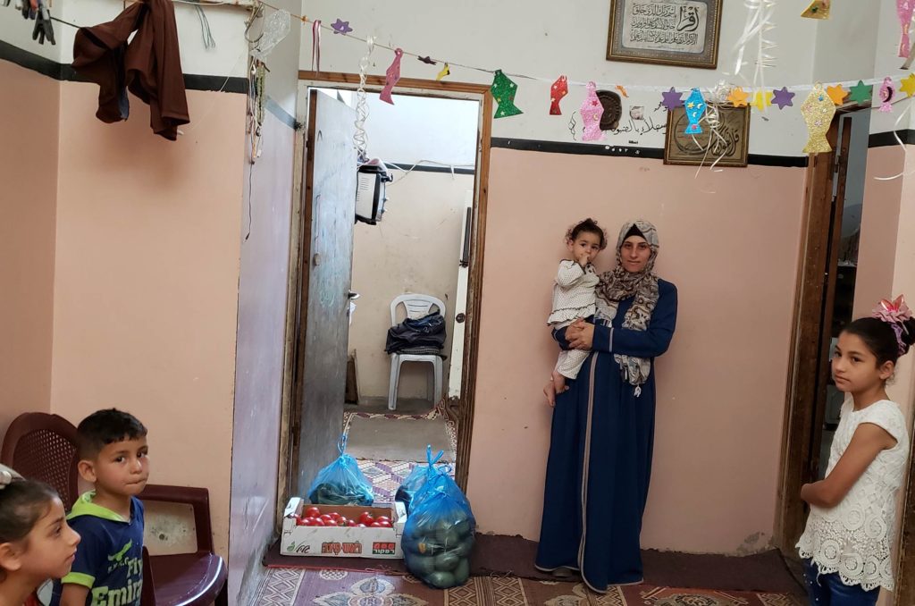 Gaza, vegetables distribution, Rahma's home Rahma with her children at their small house in Zeitoun.