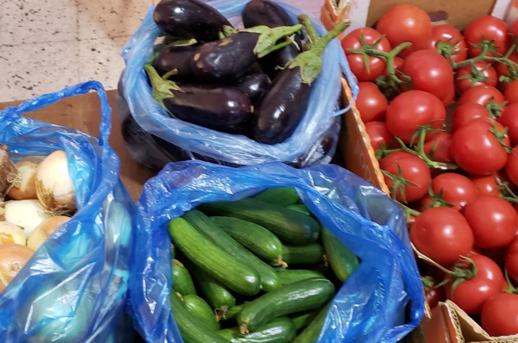 Vegetables (onions, eggplants, cucumbers, and tomatoes pictured) for distribution to families in need in Gaza after Ramadan 2020.
