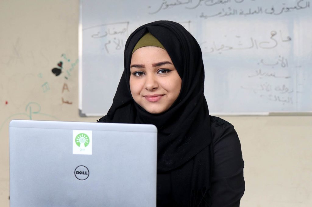 Badria, a student, uses a Thaki laptop.