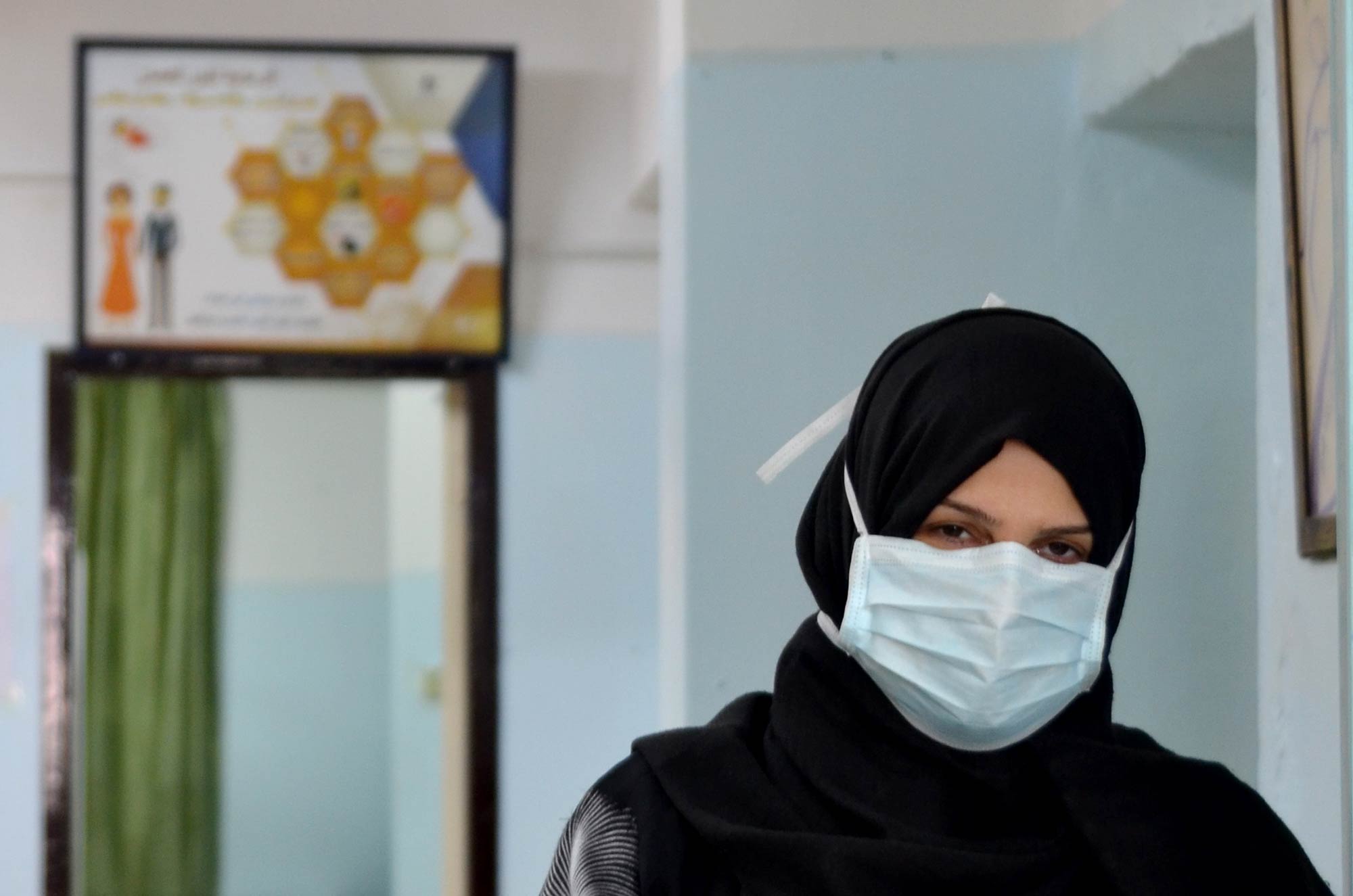Samah, wearing a mask as a precaution due to the pandemic, at the Women's Health Center in Bureij to treat an infection.