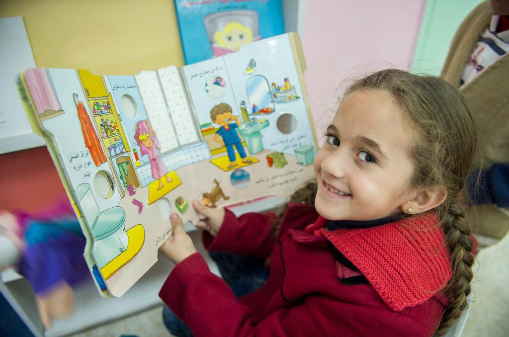 Girl reading at the Atarah Preschool in Palestine's West Bank