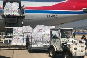 Plane cargo of donated medicines and medical supplies being unloaded.