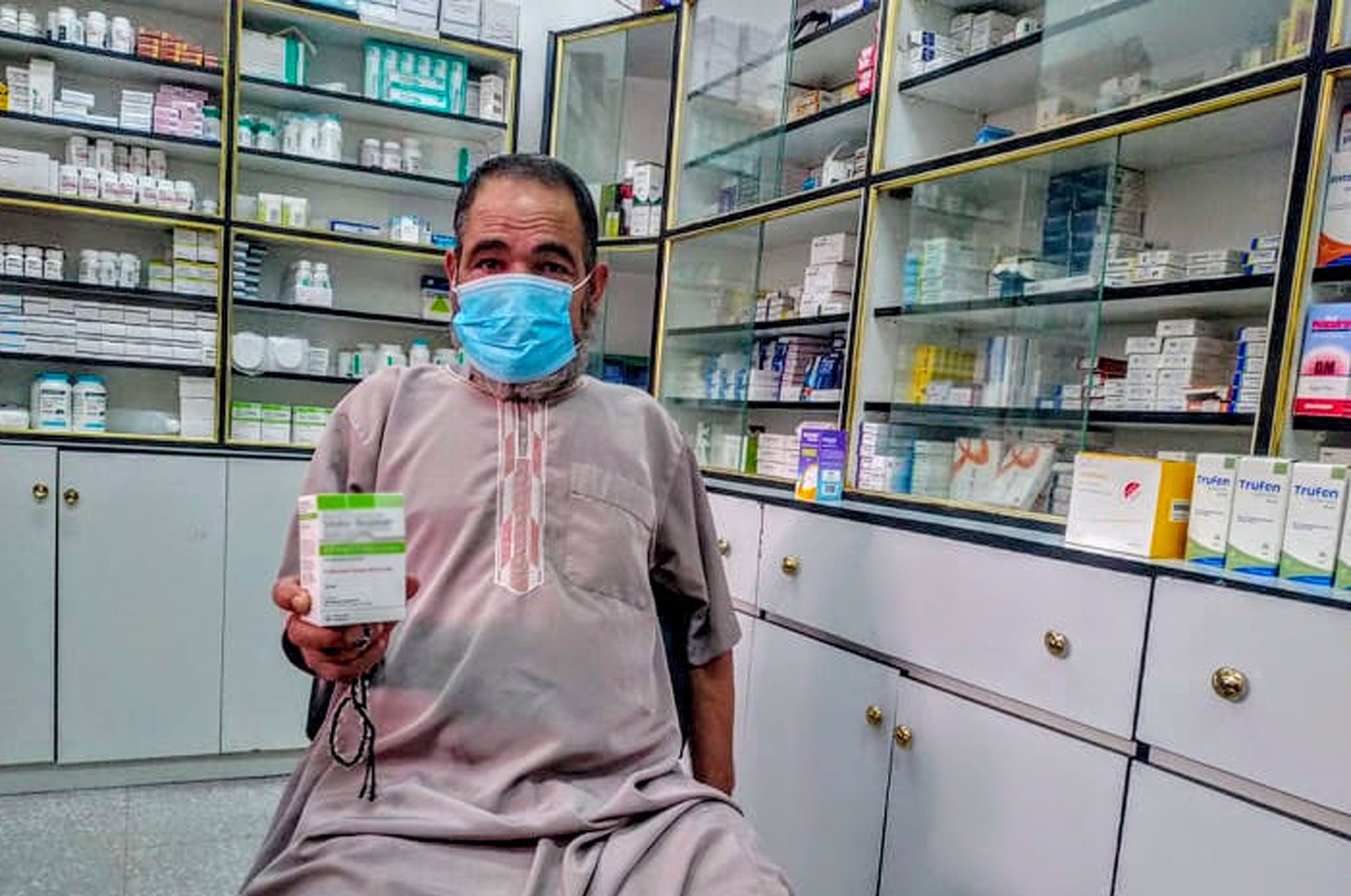 Salim holds up his medicated inhaler.