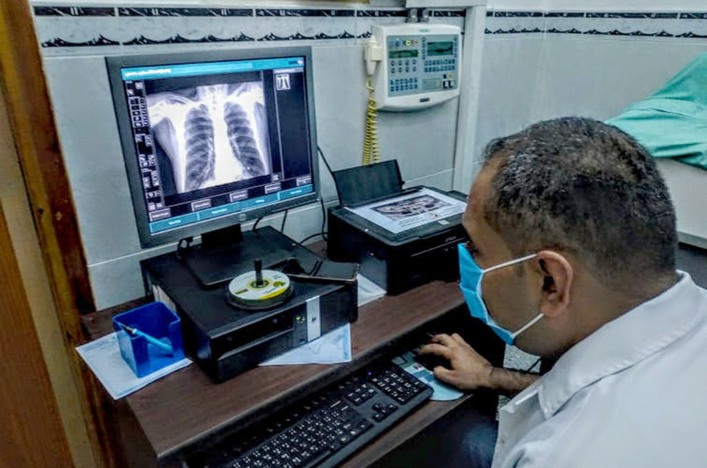 Gaza, medical-aid, inhalers, Fares Shaheen Dr. Fares Shaheen analyzes the chest X-rays of his patient, Salim.