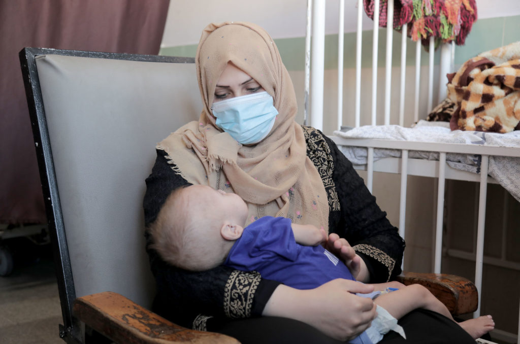 Gaza, medical-aid, calcium Umm Hassan holds her son.