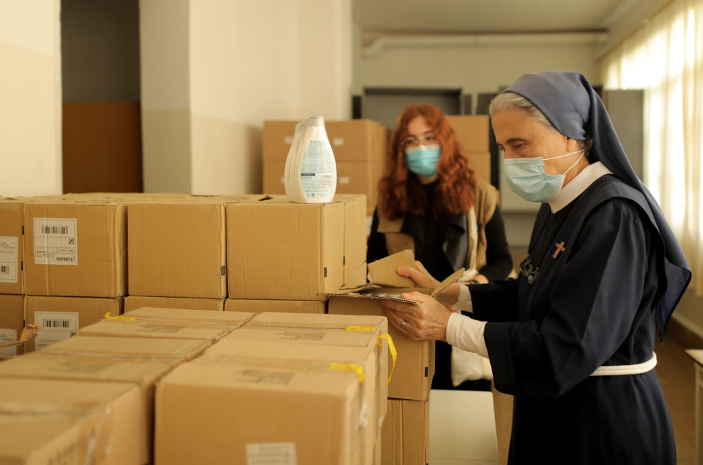 Unpacking medical aid and hygiene items at the Psychiatric Hospital of the Cross.