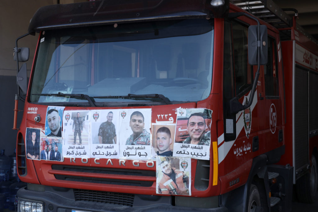 Fire truck papered with photo tributes to fallen colleagues killed in the blast.