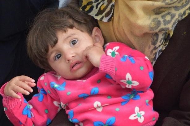 Mahmoud, a toddler looks at the camera