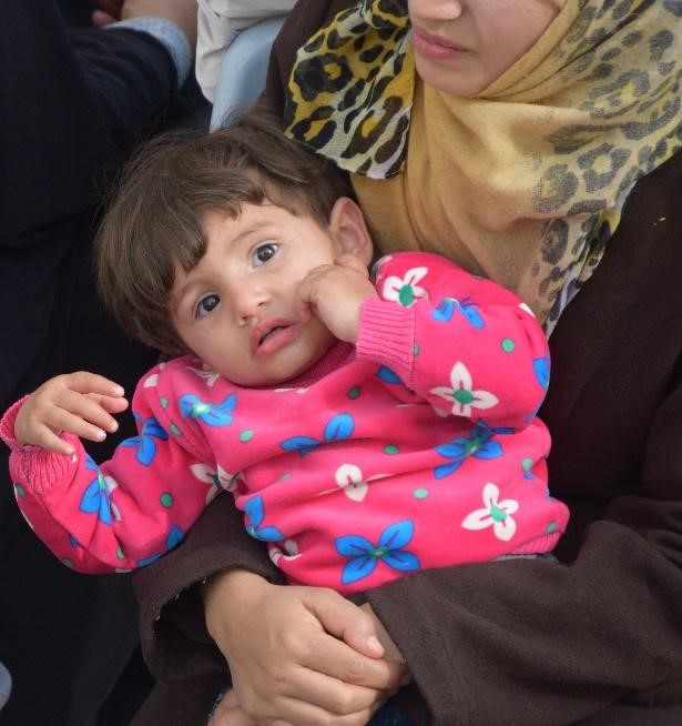 Mahmoud, a toddler looks at the camera