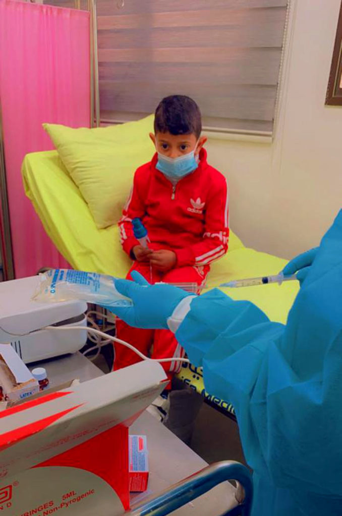medical-aid, gaza, health, palestine, pulse-of-life, saline The nurse prepares to dilute Yaseen’s bronchodilator medicine with saline.
Photo courtesy of Pulse of Life Medical Center staff.