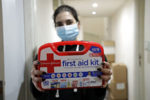 Holding up a first aid kit.