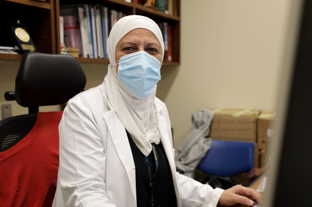 Olfat Muhammad Al-Osta at her desk at work