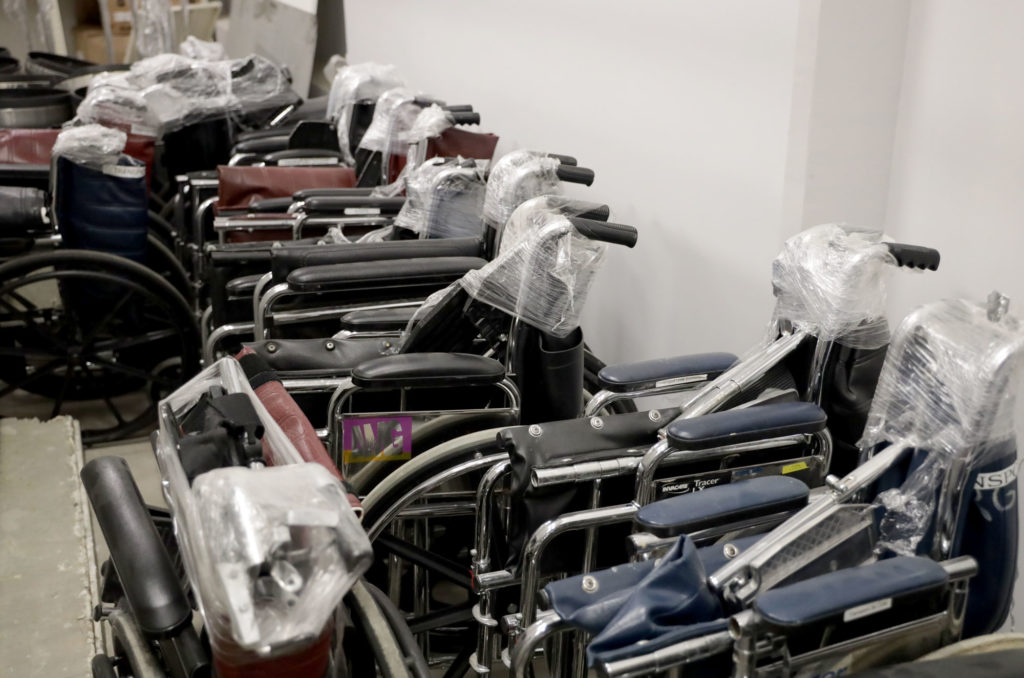 A row of collapsed wheelchairs donated by MedWish