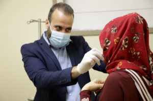 Dr. Watfa examines a burn patient.