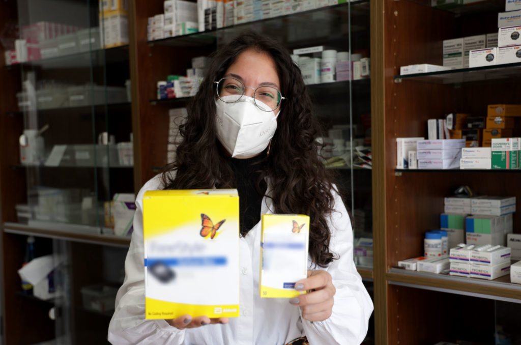 Celine Rizkallah, pharmacist, holds up boxes of the donated diabetic test strips.
